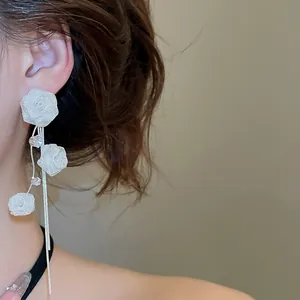 Elegant long silver mesh rose tassel earrings with delicate crystal detail on model