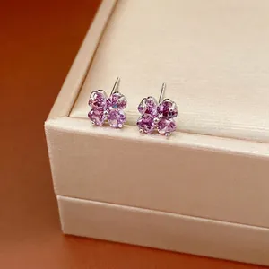 Sparkling purple zircon four-leaf clover stud earrings with silver posts on jewelry box