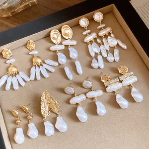 Detailed macro view showcasing various vintage baroque pearl earrings with gold finish