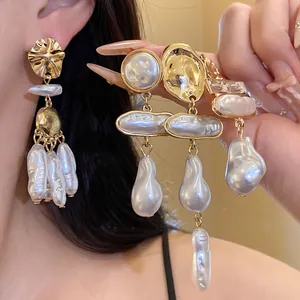 Close-up detail showing the unique textures of vintage baroque pearl earrings with gold plating