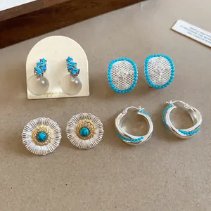 Collection of vintage silver earrings featuring daisy flower studs and turquoise accents.