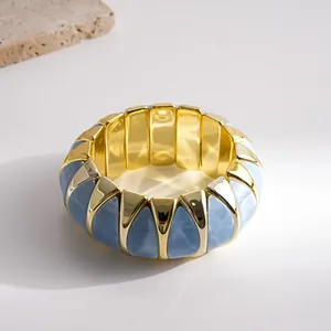 Chunky gold-plated elastic bracelet featuring elegant blue marble enamel trapezoid inserts