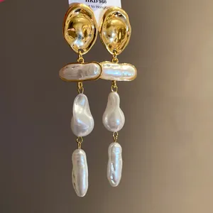 Detailed view of handmade Baroque pearl drop earrings with vintage gold metal finish