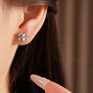 Elegant silver stud earrings featuring a light blue zircon four-leaf clover flower design