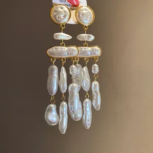 Detailed view of vintage Baroque pearl drop earrings with elegant gold accents