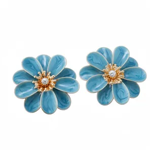 Elegant blue enamel flower stud earrings with gold accents and a sparkling crystal center