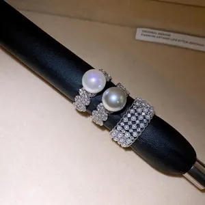 Elegant cubic zirconia pearl open rings with bear motif on black leather display