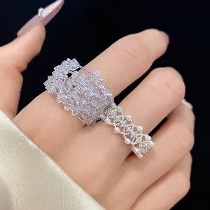Detailed view of an elegant zircon and pearl hollow openwork ring set on a finger
