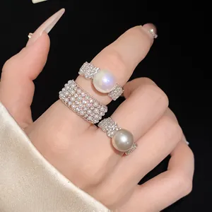 Detailed close-up shot of exquisite pearl and zircon open rings for women on hand