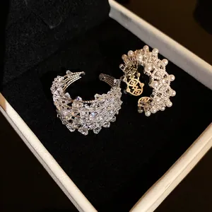 Close-up of elegant zircon and pearl hollow open rings presented in a velvet jewelry box