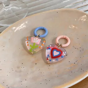 Vibrant heart-shaped glass earrings with flower patterns in a sweet dopamine style