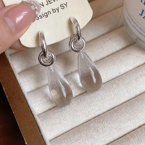 Elegant silver hoop earrings with clear resin waterdrop pendants for a minimalist look
