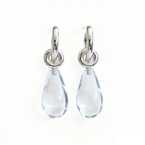 Elegant minimalist silver hoop earrings featuring clear water drop resin pendants