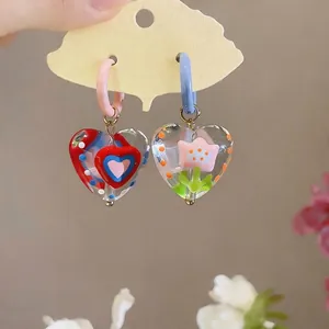 Dopamine style heart-shaped glass earrings with flower and heart motifs