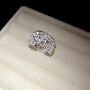 Macro view of sparkly multi-layered zircon hollow open ring in a white jewelry box