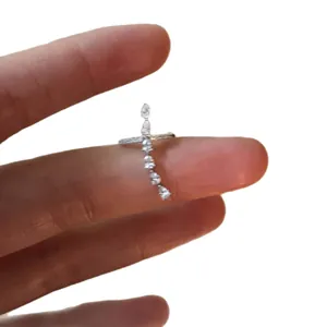 Minimalist silver ear cuff with marquise and round zircons on a white background