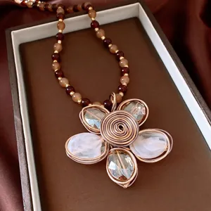 Vintage crystal beaded flower necklace with brown and gold accents for a retro look.