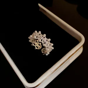 Detailed close-up of vintage silver hollow lace open ring with zircons and pearls