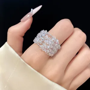 Detailed view of a sparkling zircon multi-layer open ring on a model's finger.