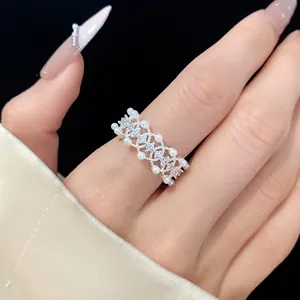 Close-up detail of an elegant silver open ring with pearls and sparkling cubic zirconia