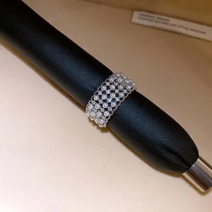 Detailed view of luxury zircon and pearl ring on a black jewelry display rod