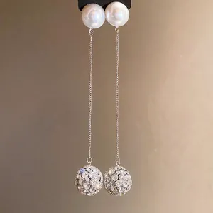 Elegant long drop pearl earrings with pavé crystal ball pendants in silver finish