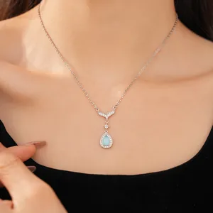 Detailed close-up of blue waterdrop fishtail necklace with zircon inlay on a model