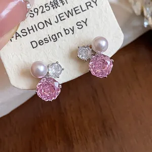 Detailed view of pink zircon flower and pearl stud earrings with S925 silver needles