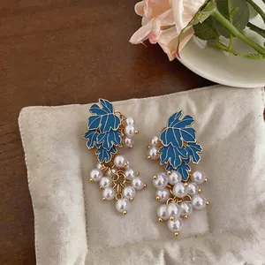 Elegant grape-shaped earrings with blue enamel leaves and white pearls.