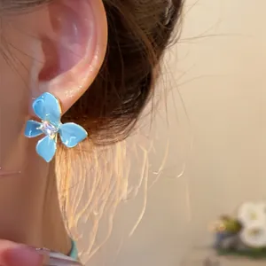 Detail view of sea salt blue flower stud earring with sparkling crystal center