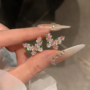 Detailed view of elegant butterfly stud earrings with colorful zircon stone inlays.