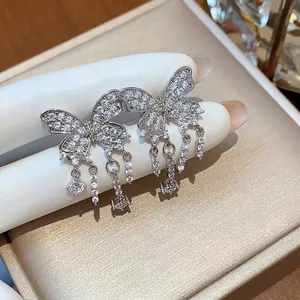 Elegant silver zircon butterfly tassel ear clips for non-pierced ears on jewelry display