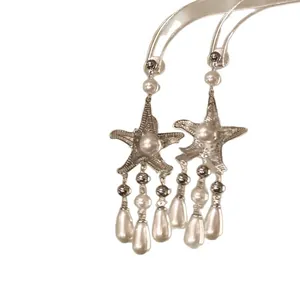 Elegant starfish dangle earrings with pearl tassels in a sophisticated vacation style.