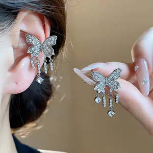 Detailed view of exquisite silver butterfly tassel ear clip with sparkling cubic zirconia stones.