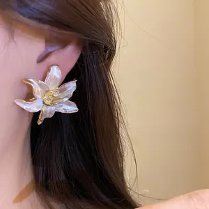 Close-up of vintage enamel flower stud earrings with elegant gold center detail