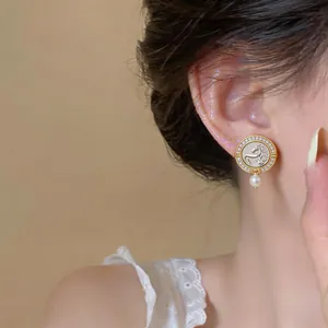 Detailed view of vintage horse head stud earring with sparkling zircon and pearl