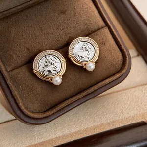 Close-up macro shot of vintage style horse head earrings featuring zircon border and pearl