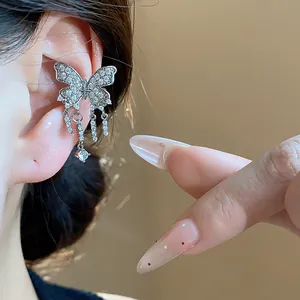 Close-up of elegant butterfly ear cuff with zircon tassels on ear