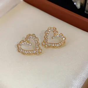 Detail view of 18k gold plated heart earrings with sparkling cubic zirconia stones