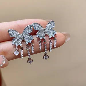 Macro view of butterfly tassel earrings with sparkling cubic zirconia stone detailing