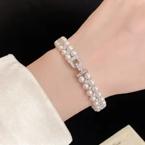 Elegant French style double-layer pearl bracelet with sparkling zircon clasp worn on female wrist