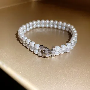 Elegant double-layer pearl bracelet with crystal-encrusted geometric clasp