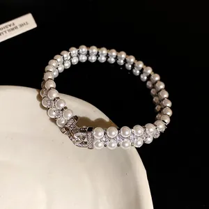 Detail view of double-layer pearl bracelet with sparkling zircon accents and clasp