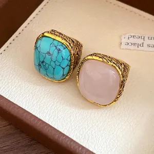 Vintage gold textured rings featuring square rose quartz and blue turquoise stones