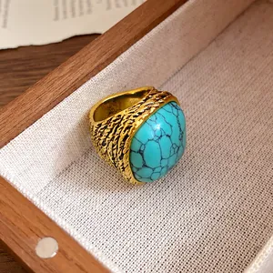 Macro detail view of a vintage gold-toned ring with a large textured turquoise stone