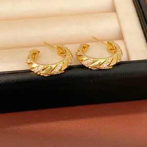 Detailed close-up of luxury 14k gold plated C-shaped hoop earrings featuring zircon inlay