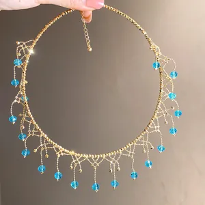 Detailed view of elegant gold lace choker with vibrant blue crystal bead tassels