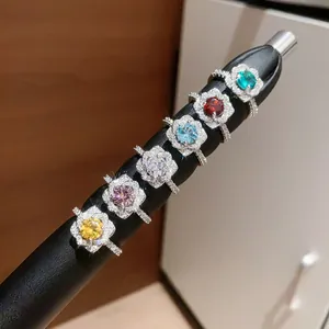 Detailed macro view of six colorful flower-shaped zircon open rings with brilliant sparkles