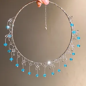 Detail view of an elegant silver choker featuring blue crystal droplets and fringe design.