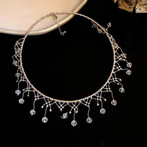 Detail macro view of an elegant vintage lace tassel choker with clear crystal drops